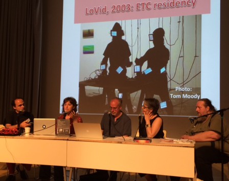 panel of five people with screen in background