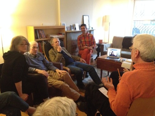Five people sit in a living room